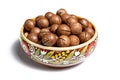 Fresh organic peeled macadamia nuts in ceramic bowl isolated on white Royalty Free Stock Photo