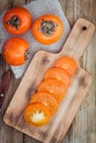Fresh organic persimmon with slices Royalty Free Stock Photo