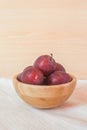 Fresh organic plums in a wooden bowl. Royalty Free Stock Photo