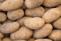 Fresh Organic Potatoes Stack on Market Stall Royalty Free Stock Photo