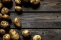 Fresh organic potatoes varieties over plank rustic background Royalty Free Stock Photo