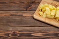 Fresh organic products. Raw Potatoes Diced. Wooden plank. Flat lay.