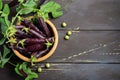 Fresh organic purple green peas in a wooden bowl on rustic wooden table. Royalty Free Stock Photo