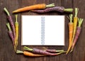 Fresh organic rainbow carrots with Recipes book