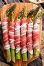 Fresh Organic raw Bacon Wrapped Asparagus on wooden table. Royalty Free Stock Photo
