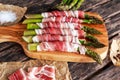 Fresh Organic raw Bacon Wrapped Asparagus on wooden table. Royalty Free Stock Photo