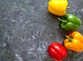 Fresh organic ripe bell peppers or capsicum on grey table, top view. Fresh vegetables bell red, yellow, Green, orange pepper Royalty Free Stock Photo