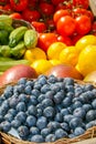 Fresh organic ripe blueberries in a basket and various fruits and vegetables Royalty Free Stock Photo