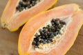 Fresh organic ripe papaya fruit cut in half on a wooden board. Exotic fruits, healthy eating concept Royalty Free Stock Photo