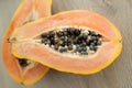 Fresh organic ripe papaya fruit cut in half on a wooden board. Exotic fruits, healthy eating concept Royalty Free Stock Photo