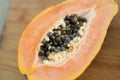 Fresh organic ripe papaya fruit cut in half on a wooden board. Exotic fruits, healthy eating concept Royalty Free Stock Photo