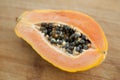 Fresh organic ripe papaya fruit cut in half on a wooden board. Exotic fruits, healthy eating concept Royalty Free Stock Photo