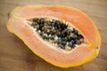 Fresh organic ripe papaya fruit cut in half on a wooden board. Exotic fruits, healthy eating concept Royalty Free Stock Photo