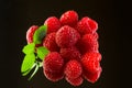 Fresh organic ripe raspberries on black background