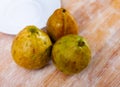 Fresh organic red guavas fruit cut in half on a wooden board. Exotic fruits, healthy eating concept