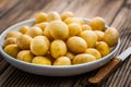 Fresh organic small potatoes in bowl with knife