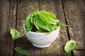 Fresh organic sorrel leaves in bowl on wooden table Royalty Free Stock Photo