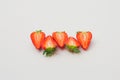 Fresh organic strawberries halved and arranged on a white background. Royalty Free Stock Photo