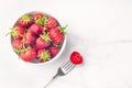 Fresh organic strawberry in the white bowl and fork, on the white background Royalty Free Stock Photo