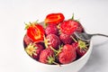 Fresh organic strawberry in the white bowl and fork, on the white background Royalty Free Stock Photo