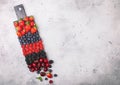 Fresh organic summer berries mix on black marble board on light kitchen table background. Raspberries, strawberries, blueberries, Royalty Free Stock Photo