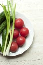 Fresh organic tomatoes and cucumbers with green onions on a white plate Royalty Free Stock Photo