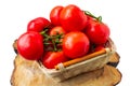 Fresh organic tomatoes with water drops in a basket isolated on white. Close up Royalty Free Stock Photo