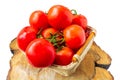 Fresh organic tomatoes with water drops in a basket isolated on white. Close up Royalty Free Stock Photo