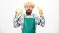 Fresh organic vegetable harvest. Hipster gardener in apron hold vegetable. Man bearded presenting corncob maize and