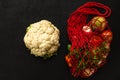 Fresh organic vegetables in eco friendly mesh bag and a cauliflower on a black background. Zero waste, free from plastic Royalty Free Stock Photo