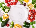 Fresh Organic Vegetables frame around an empty plate. Healthy food or diet concept Royalty Free Stock Photo