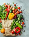 Fresh organic vegetables, fruits, herbs and spices in a recycled paper bag on light grey background with copy space Royalty Free Stock Photo