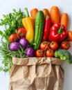 Fresh organic vegetables and fruits in a recycled paper shopping bag isolated on white background with copy space Royalty Free Stock Photo