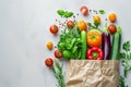 Fresh organic vegetables and fruits in a recycled paper shopping bag isolated on white background with copy space Royalty Free Stock Photo