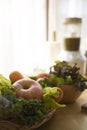 Organic vegetables and fruits in wicker basket and blended on wooden table for making vegetarian food. Royalty Free Stock Photo