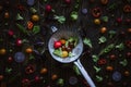 Fresh organic vegetables in kitchen colander. Green peas, broccoli, tomato and radish on the wooden table. Top view.