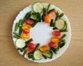 Fresh Organic Vegetables on wooden Table Around White Plate with copy space for your text. Royalty Free Stock Photo