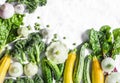 Fresh organic vegetables - zucchini, squash, cucumbers, broccoli, onions, garlic, chard, green peas on a light background with cop Royalty Free Stock Photo