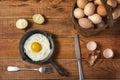 Fresh organic village eggs on wooden table, healthy food,  village food. black pan with fried egg. Royalty Free Stock Photo