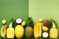 Fresh organic yellow fruits over green background. Monochrome concept with banana, coconut, pineapple, lemon, melon. Top Royalty Free Stock Photo