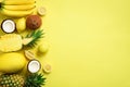 Fresh organic yellow fruits over sunny background. Monochrome concept with banana, coconut, pineapple, lemon, melon. Top Royalty Free Stock Photo