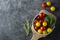 Fresh, organic yellow and red tomatoes in plate, isolated over dark background Royalty Free Stock Photo