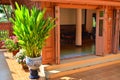 Fresh ornament plants beside the doors of teak house