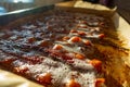 Close up to bacon cooking on a cookie sheet with foam bubbling on top Royalty Free Stock Photo