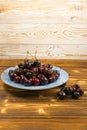 Fresh Overripe ripe Cherries on Blue Rustic Wooden Background Royalty Free Stock Photo