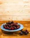 Fresh Overripe ripe Cherries on Blue Rustic Wooden Background Royalty Free Stock Photo