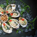 Fresh oysters close-up on a dish, served with oysters, lemon and ice. Healthy seafood. Oyster dinner with champagne in a Royalty Free Stock Photo