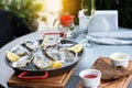Fresh oysters with lemon`s slices in ice and champagne. Restaurant delicacy. Saltwater oysters dish. Royalty Free Stock Photo