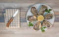 Fresh oysters white plate and lemon on wooden desk Royalty Free Stock Photo