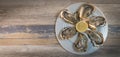 Fresh oysters white plate and lemon on wooden desk